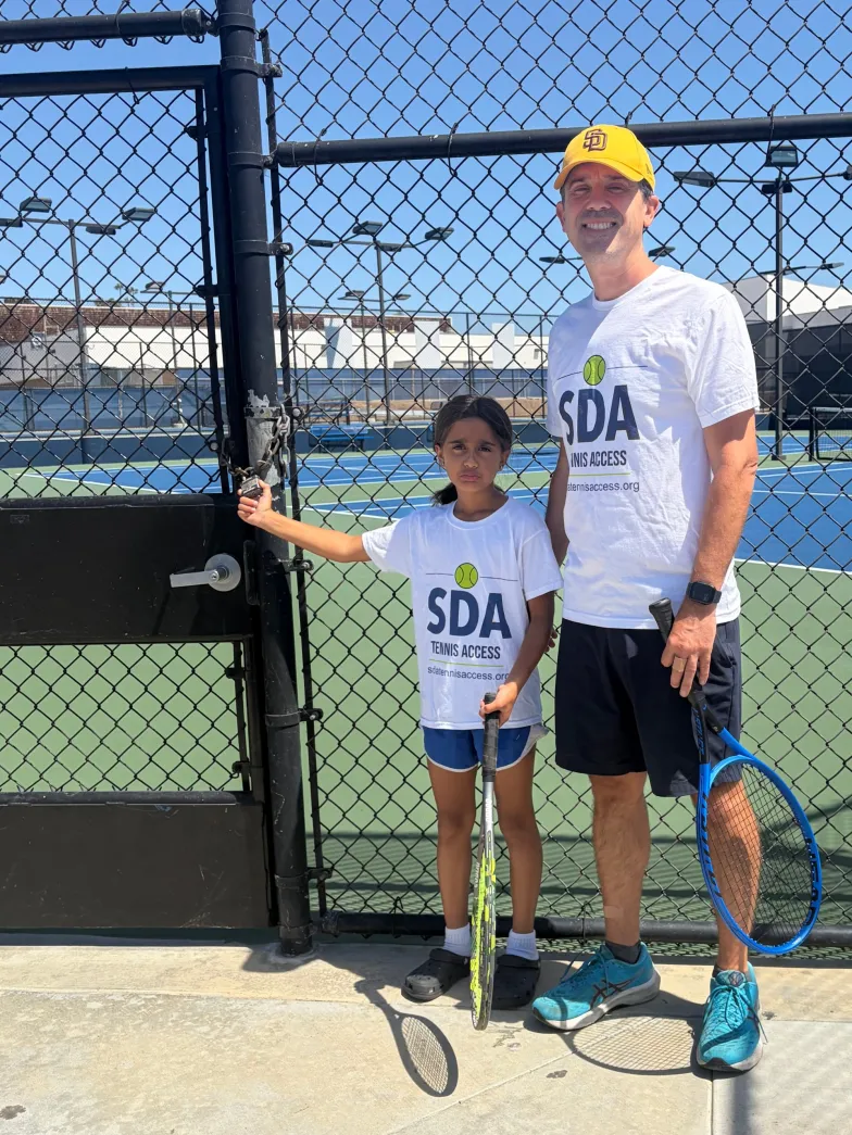 Jeff Sherin and his daughter standing outside the locked San Dieguito Academy tennis courts